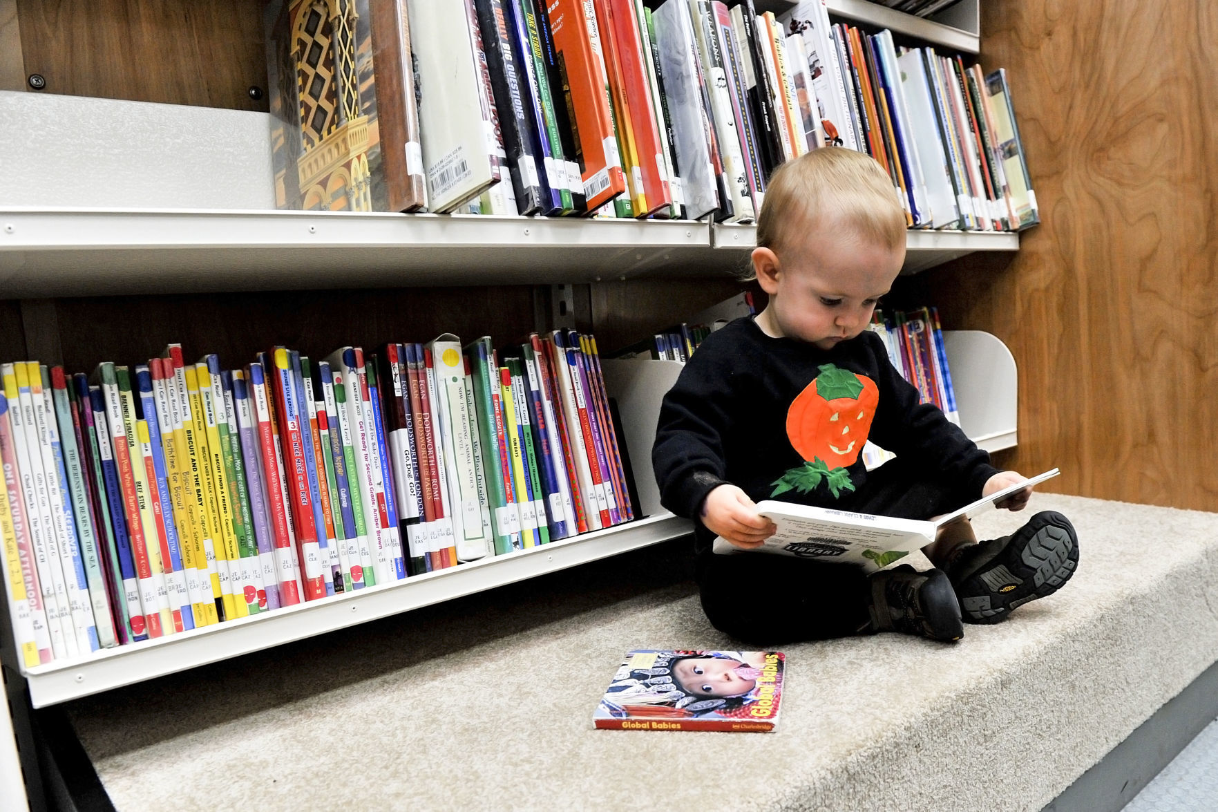 1-year-old Emory Kreissler looks through a book in 2012